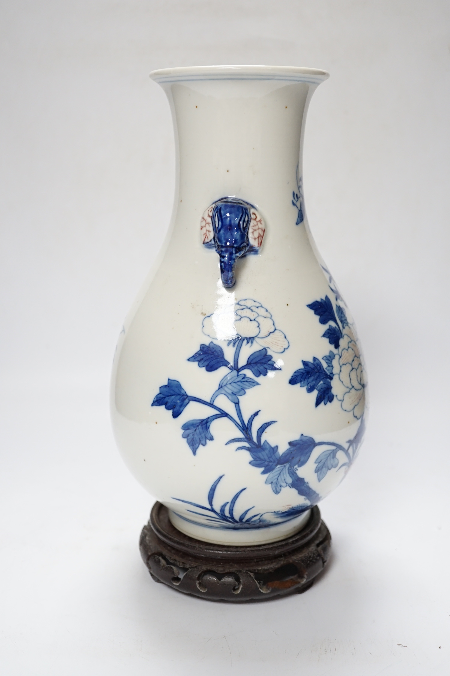 A Chinese underglaze blue and copper red pear shaped vase, on stand, 31cm high including stand